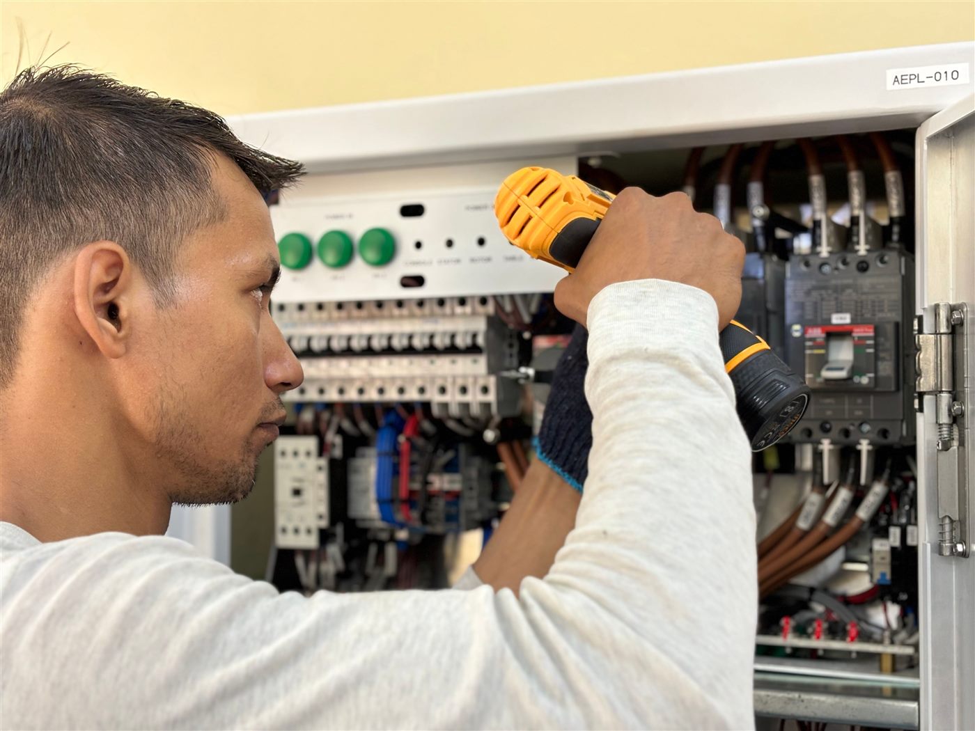 Electrician servicing a commercial distribution board